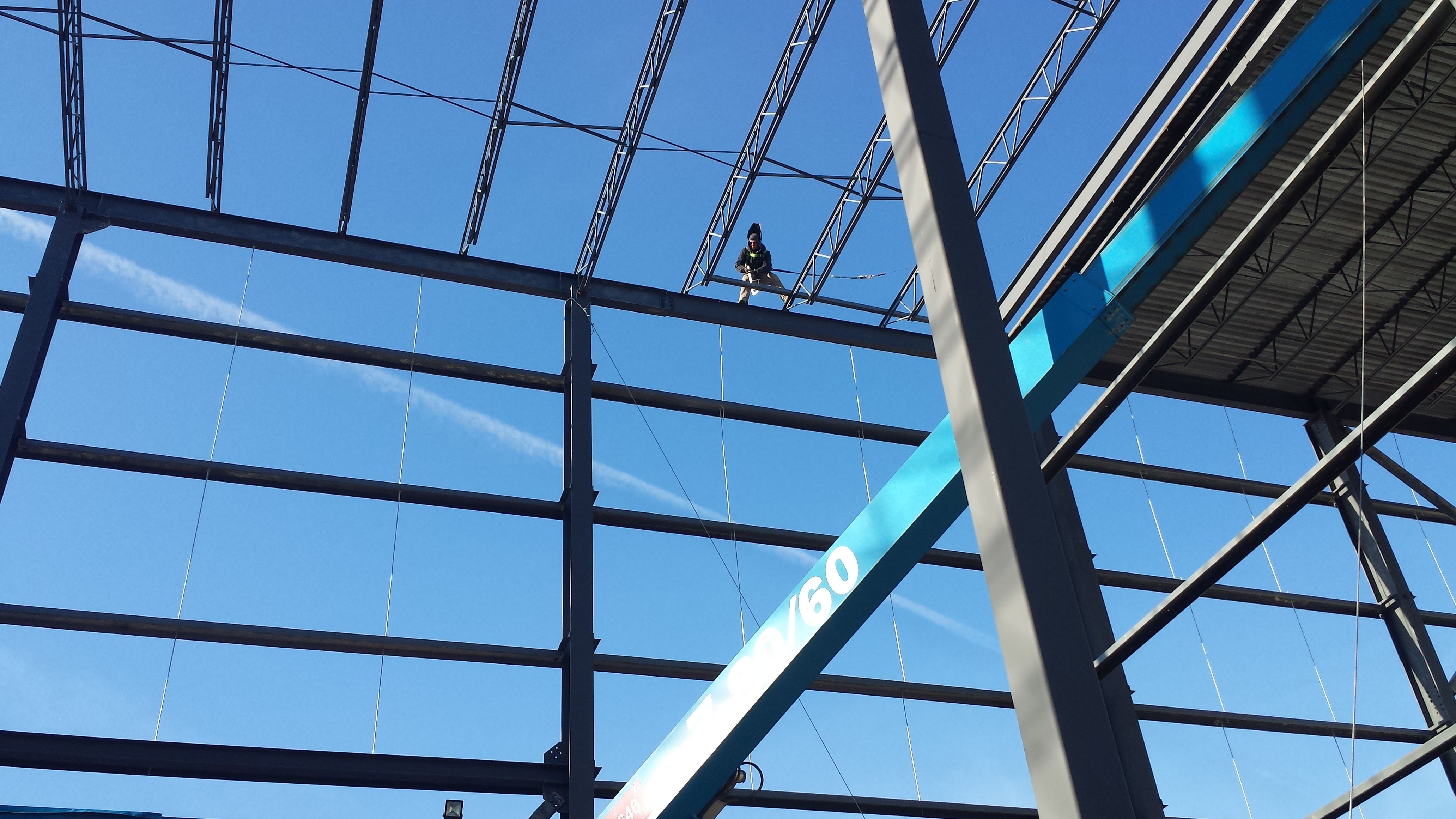 Steel worker on open web joists during a Weld Plus structural steel installation