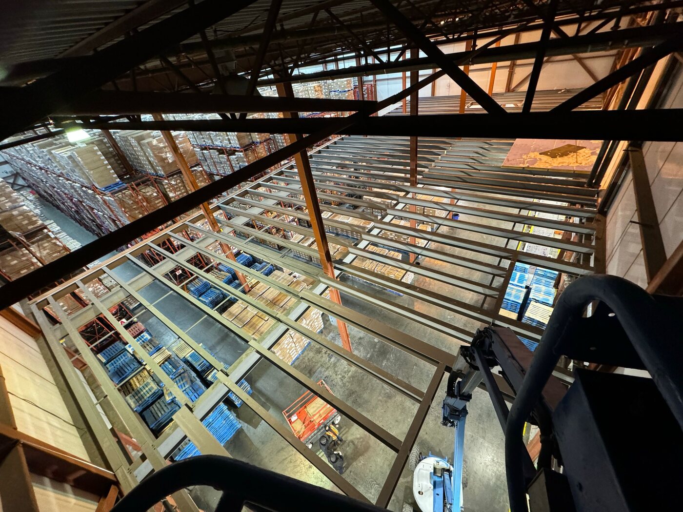 Steel mezzanine deck and support framing inside a warehouse, fabricated by Weld Plus