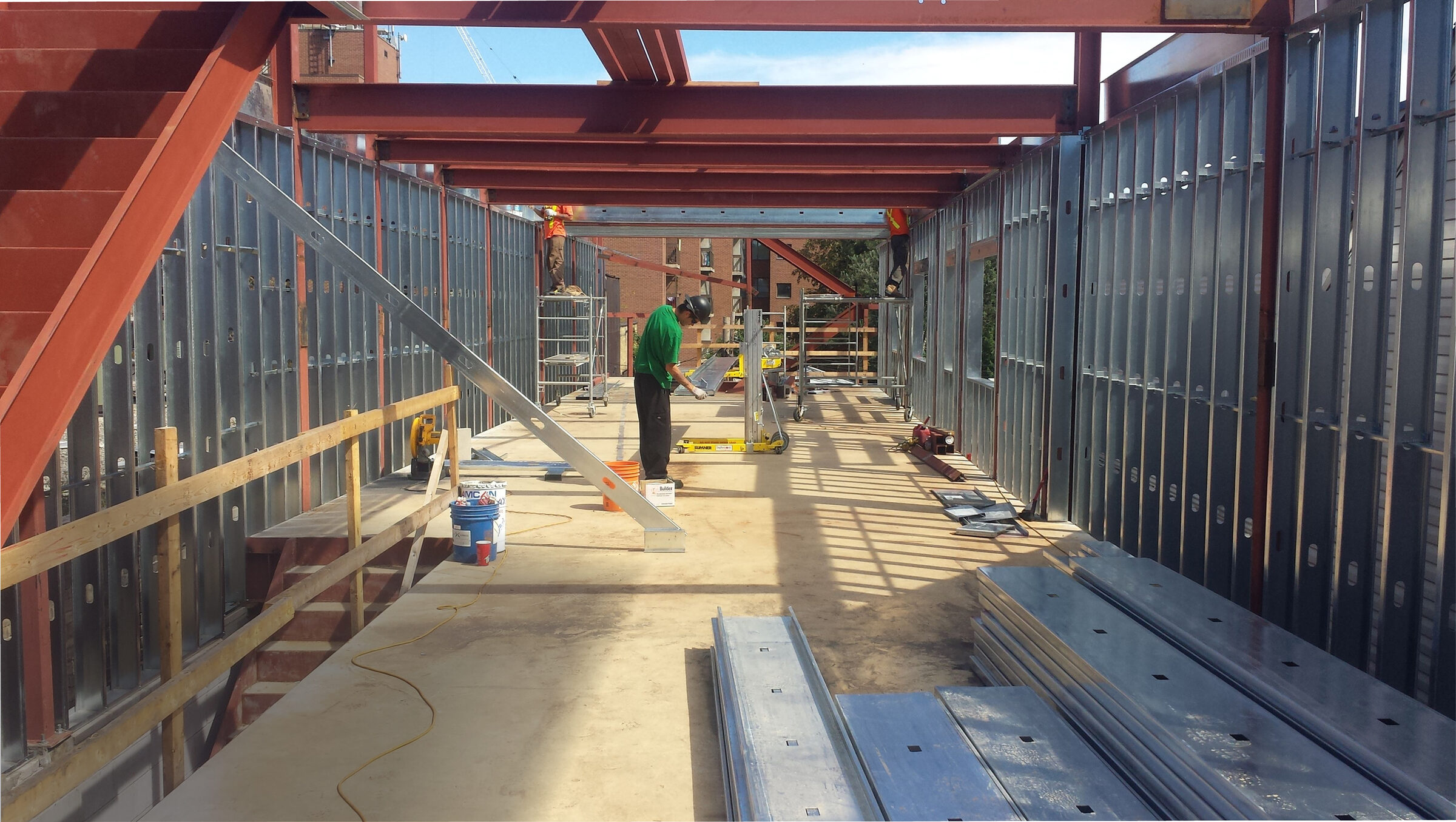 Weld Plus crew installing steel framing inside a building under construction
